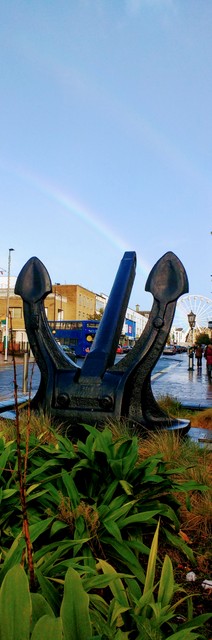 There is a long stretch of road from the watefront right through the spine of the city called the QE2 Mile - named for the royal cruise ship. This anchor for that might vessel rests here along - I caught a double-rainbow in the background :)