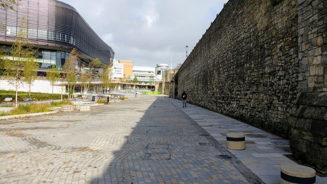 21st century modern restaurants on the left... ancient Medieval defence walls on right