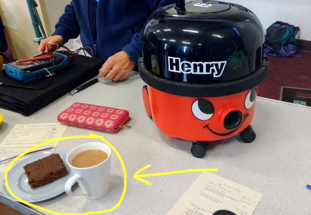 Henry vacuum cleaner getting some TLC - this picture also points out a cup of tea and brownie - did I mention that volunteers get a token for one cup of tea and cake for FREE?!?